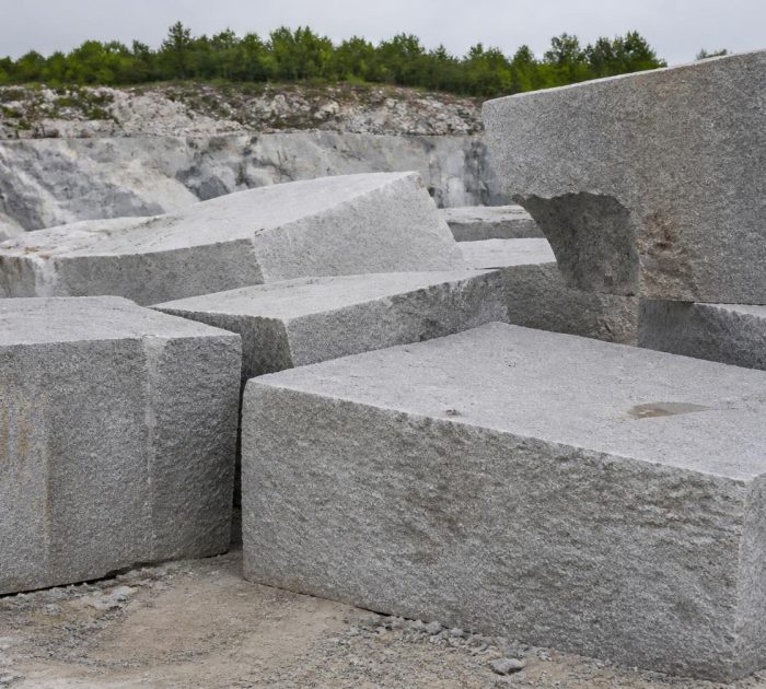 Rough-cut Elberton granite blocks at a quarry, showing the exposed rock face and stacked stone